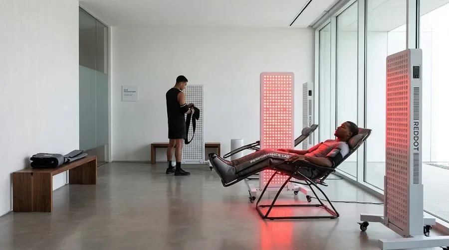 Athletes using customized red light therapy panels in a professional sports reco